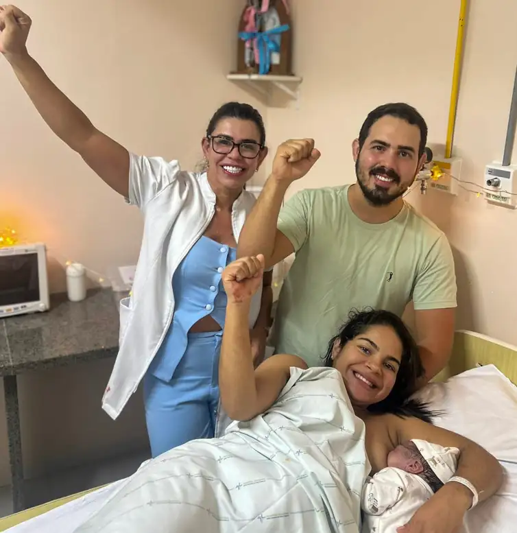 26/01/2026 - Formação de enfermeiros obstétricos tem impacto positivo, mas número precisa ser ampliado. Valéria, o marido, a bebê Maria Catarina e a enfermeira obstétrica Maria Luiza Bezerra. Foto: Valéria Monteiro/arquivo pessoal